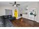 Open-concept living room with hardwood floors, a breakfast bar, and a view into the kitchen at 3015 Thornhill Rd, Winter Haven, FL 33880