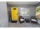 Inviting front porch with seating and a vibrant yellow door, creating a warm welcome at 3015 Thornhill Rd, Winter Haven, FL 33880