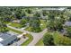 The aerial view captures a home nestled within a lush, green neighborhood with mature trees at 3560 Sandpiper Ln, Mulberry, FL 33860