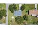 The aerial view shows a home with a well-maintained yard and mature trees in a quiet neighborhood setting at 3560 Sandpiper Ln, Mulberry, FL 33860
