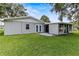 Backyard featuring a well-maintained lawn, enclosed patio and large windows at 3560 Sandpiper Ln, Mulberry, FL 33860