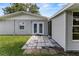 Exterior view of the back of the house with a patio, and well-maintained lawn at 3560 Sandpiper Ln, Mulberry, FL 33860