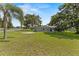 A fully fenced backyard featuring a large grassy area, ideal for outdoor activities and privacy at 3560 Sandpiper Ln, Mulberry, FL 33860