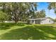 Lush backyard featuring a mature, shady tree creating a serene outdoor environment at 3560 Sandpiper Ln, Mulberry, FL 33860