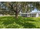 Spacious backyard showcasing a mature tree, offering shade and character to the home's outdoor space at 3560 Sandpiper Ln, Mulberry, FL 33860