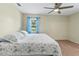 This cozy bedroom features a ceiling fan and natural light from the window at 3560 Sandpiper Ln, Mulberry, FL 33860