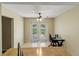 This dining area features a ceiling fan, double doors to the outside, and tile flooring at 3560 Sandpiper Ln, Mulberry, FL 33860