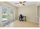 Bright dining area features tile flooring, ceiling fan, and double doors leading to the outdoors at 3560 Sandpiper Ln, Mulberry, FL 33860