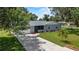 Charming single-story home featuring a well-maintained lawn, landscaping, and attached garage at 3560 Sandpiper Ln, Mulberry, FL 33860
