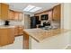 Well-lit kitchen with wooden cabinets, modern appliances, and laminate countertops at 3560 Sandpiper Ln, Mulberry, FL 33860