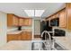 Well-lit kitchen with wooden cabinets, modern appliances, and laminate countertops at 3560 Sandpiper Ln, Mulberry, FL 33860