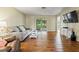 Open-concept living room with laminate flooring, a gray sofa, and plenty of natural light at 3560 Sandpiper Ln, Mulberry, FL 33860
