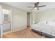 This bedroom features neutral carpeting, a ceiling fan, and an ensuite bathroom at 3560 Sandpiper Ln, Mulberry, FL 33860