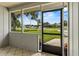 View from the screened-in porch looks out onto a well-manicured lawn at 3560 Sandpiper Ln, Mulberry, FL 33860