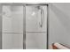 Bright bathroom features a shower with glass doors, white tile, and silver fixtures at 3739 Peregrine Way, Lakeland, FL 33811