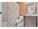 Full bathroom with a shower-tub combo, decorative shower curtain, and dark wood vanity at 3739 Peregrine Way, Lakeland, FL 33811