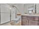 Clean bathroom features a shower with glass doors, a toilet, and a dark vanity with sink at 3739 Peregrine Way, Lakeland, FL 33811