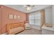 Charming Bedroom featuring a wooden crib, comfortable chair, and soft, neutral tones for a calming atmosphere at 3739 Peregrine Way, Lakeland, FL 33811