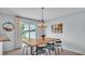 Stylish dining room with a modern table, scenic backyard view, and elegant chandelier for a pleasant dining experience at 3739 Peregrine Way, Lakeland, FL 33811