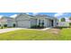 Charming single-story home featuring a gray exterior, well-manicured lawn, and an attached two-car garage at 3739 Peregrine Way, Lakeland, FL 33811