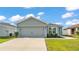 Charming single-story home featuring a gray exterior, well-manicured lawn, and an attached two-car garage at 3739 Peregrine Way, Lakeland, FL 33811