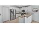 Well-lit kitchen features stainless steel appliances, granite countertops, and white cabinetry at 3739 Peregrine Way, Lakeland, FL 33811