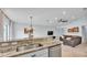 Open concept kitchen features granite counters, stainless appliances, and views to the living room at 3739 Peregrine Way, Lakeland, FL 33811