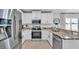 Bright kitchen features granite countertops, stainless steel appliances, and white cabinetry at 3739 Peregrine Way, Lakeland, FL 33811