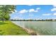 Picturesque view of the lake, showcasing a serene waterfront community with lush greenery and charming homes at 3739 Peregrine Way, Lakeland, FL 33811