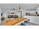 Inviting living area featuring modern decor, a large wooden dining table, and an open concept design with views of the kitchen at 3739 Peregrine Way, Lakeland, FL 33811