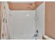 Clean shower area with white tiling, a floral shower curtain, and modern fixtures at 3739 Peregrine Way, Lakeland, FL 33811