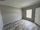 Bright bedroom with wood-look flooring, fresh paint, and natural light at 3780 Pioneer Trails St, Lakeland, FL 33810