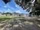 Spacious backyard with mature trees, highlighting the home's serene setting on a sunny day at 3780 Pioneer Trails St, Lakeland, FL 33810