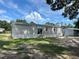 Charming single-story home with light gray siding and well-maintained yard under a sunny sky at 3780 Pioneer Trails St, Lakeland, FL 33810