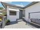 Backyard deck featuring a metal swing and a backdoor to the home at 3854 Feather Dr, Lakeland, FL 33812