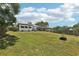 Wide open backyard featuring a patio area, well-kept grass, and privacy fencing at 3854 Feather Dr, Lakeland, FL 33812