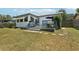Backyard with well-maintained lawn, a patio, and fresh landscaping at 3854 Feather Dr, Lakeland, FL 33812