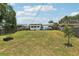 Large backyard featuring a well-maintained lawn, a patio, and wooden fencing at 3854 Feather Dr, Lakeland, FL 33812