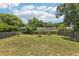 Large backyard with lush green grass and mature trees, offering ample space for outdoor activities at 3854 Feather Dr, Lakeland, FL 33812