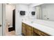 Bathroom with a vanity featuring a white countertop and a large mirror above at 3854 Feather Dr, Lakeland, FL 33812