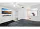 Bedroom featuring a ceiling fan, wall-mounted TV, and doorway to bath at 3854 Feather Dr, Lakeland, FL 33812