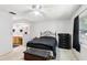Bright bedroom with ceiling fan and an adjoining bath area at 3854 Feather Dr, Lakeland, FL 33812