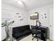 Bright bedroom with a futon, wall-mounted TV, treadmill, and 'Live, Love, Laugh' wall decor at 3854 Feather Dr, Lakeland, FL 33812