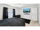 Bedroom featuring a ceiling fan, wall-mounted TV, and black-out curtains at 3854 Feather Dr, Lakeland, FL 33812