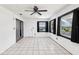 Bright bonus room with white tile flooring, multiple windows, and a sliding glass door at 3854 Feather Dr, Lakeland, FL 33812