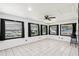 Bright, white-tiled bonus room featuring multiple windows and a ceiling fan at 3854 Feather Dr, Lakeland, FL 33812