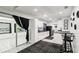 Open kitchen with white cabinets, black accents, and adjacent dining area at 3854 Feather Dr, Lakeland, FL 33812
