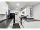 Bright kitchen featuring sleek, white cabinetry and modern black appliances at 3854 Feather Dr, Lakeland, FL 33812