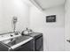 Laundry room featuring a modern washer and dryer set with a 'Laundry Self Serve' sign at 3854 Feather Dr, Lakeland, FL 33812