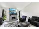 Bright living room featuring a fireplace, large window and an entertainment center at 3854 Feather Dr, Lakeland, FL 33812